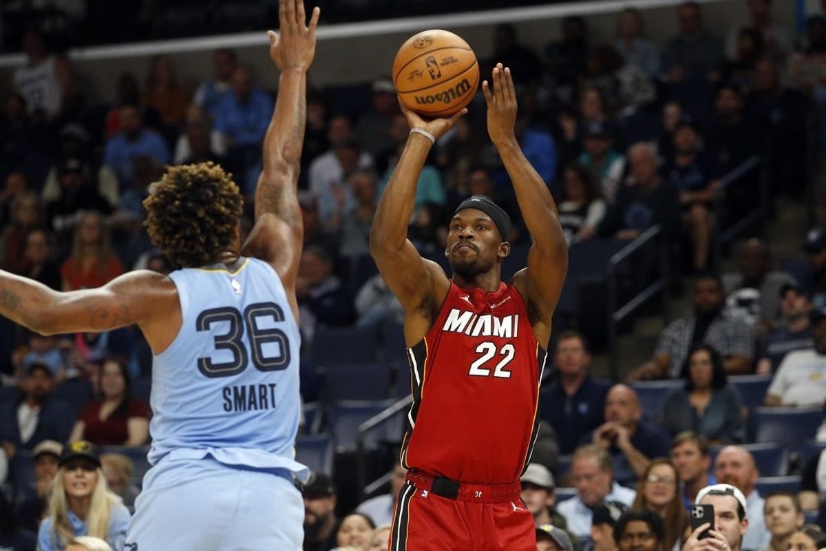 Nov 8, 2023; Memphis, Tennessee, USA; Miami Heat forward Jimmy Butler (22) shoots for three as Memphis Grizzlies guard Marcus Smart (36) defends during the first half at FedExForum.