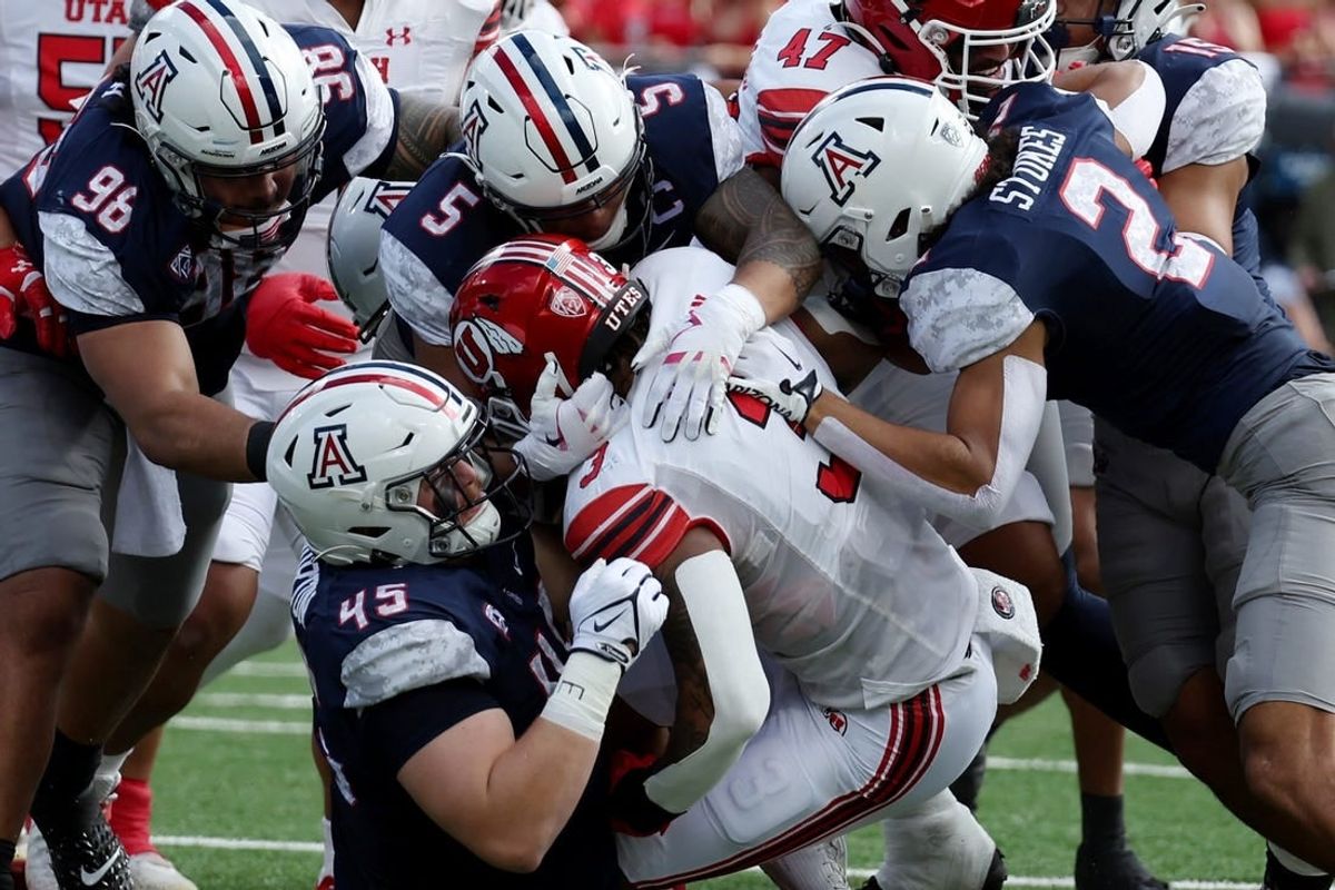 Nov 18, 2023; Tucson, Arizona, USA; Utah Utes running back Ja'Quinden Jackson (3) is tackled by Arizona Wildcats defensive lineman Bill Norton (45) and linebacker Jacob Manu (5) during the first half at Arizona Stadium.