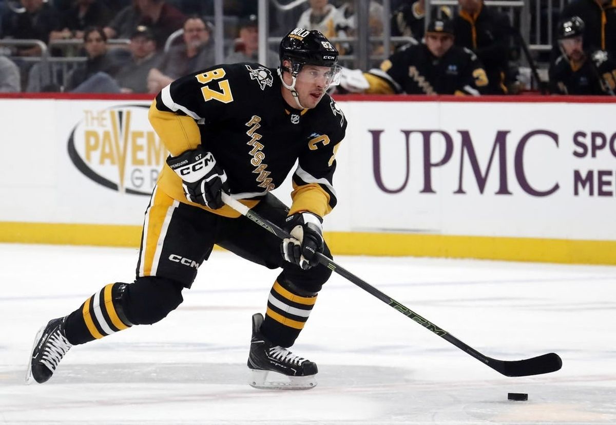 Mar 14, 2024; Pittsburgh, Pennsylvania, USA; Pittsburgh Penguins center Sidney Crosby (87) moves the puck up ice against the San Jose Sharks during the first period at PPG Paints Arena.