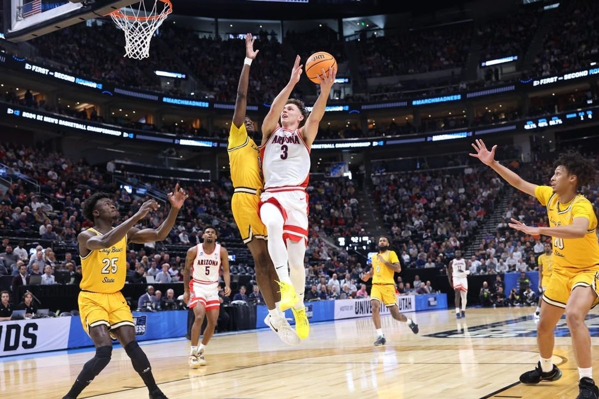 Mar 21, 2024; Salt Lake City, UT, USA;  Arizona Wildcats guard Pelle Larsson (3) drives to the net against  Long Beach State 49ers forward Amari Stroud (1) during the first half in the first round of the 2024 NCAA Tournament at Vivint Smart Home Arena-Delta Center.