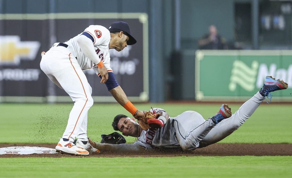 May 1, 2024; Houston, Texas, USA;  Cleveland Guardians shortstop Brayan Rocchio (4) is tagged out by Houston Astros shortstop Jeremy Pena (3) on a play during the third inning at Minute Maid Park.