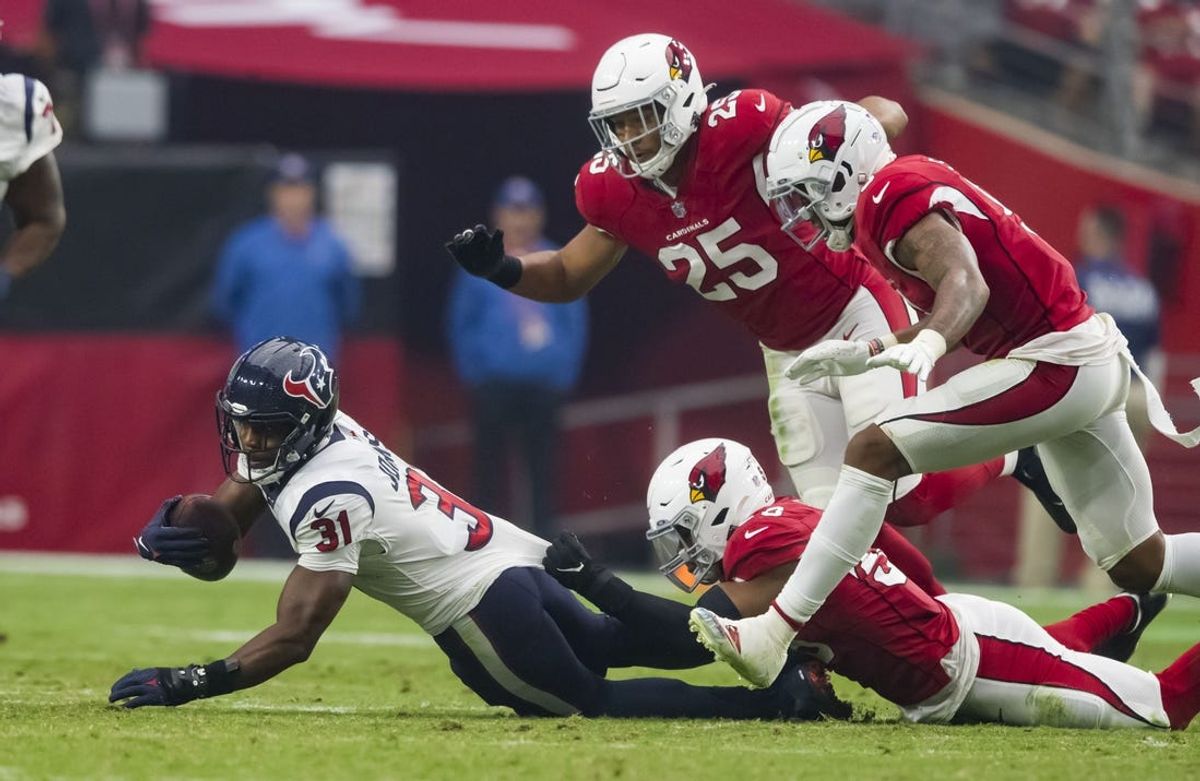 Oct 24, 2021; Glendale, Arizona, USA; Houston Texans running back David Johnson (31) is tackled by the Arizona Cardinals defense at State Farm Stadium. Mandatory Credit: Mark J. Rebilas-USA TODAY Sports