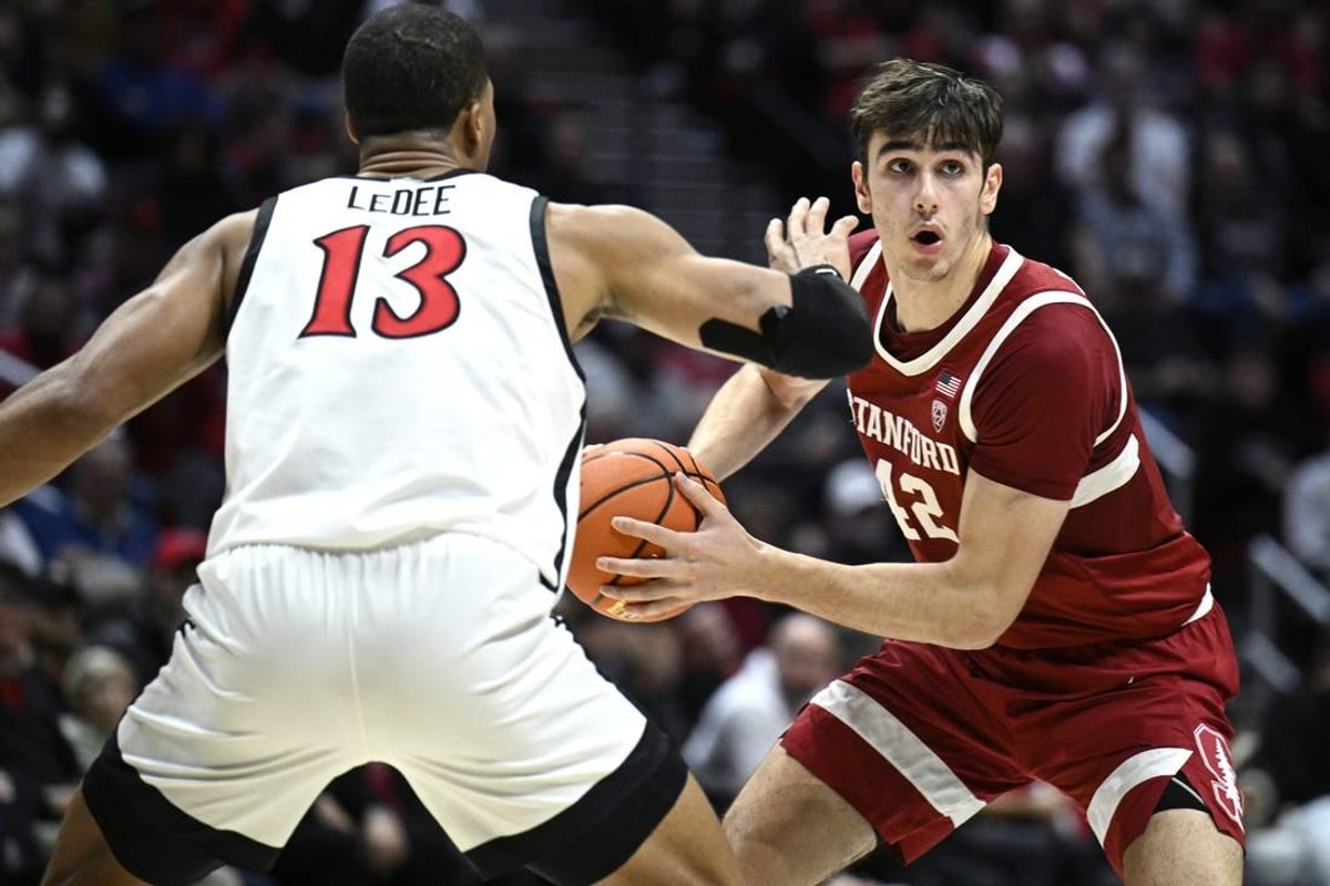 Dec 21, 2023; San Diego, California, USA; Stanford Cardinal forward Maxime Raynaud (42) looks to pass defended by San Diego State Aztecs forward Jaedon LeDee (13) during the second half at Viejas Arena.