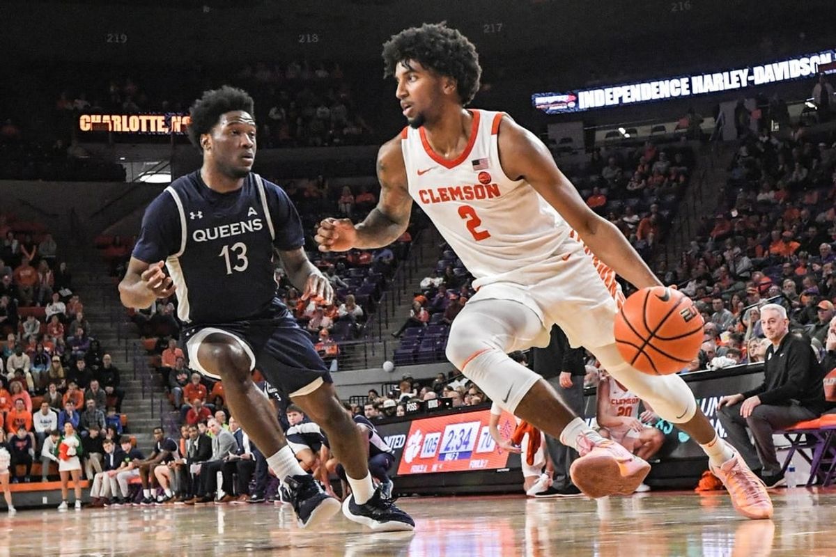 Dec 22, 2023; Clemson, South Carolina, USA; Clemson sophomore guard Dillon Hunter (2) dribbles near Queens University guard Dayton Albury (13) during the second half at Littlejohn Coliseum.