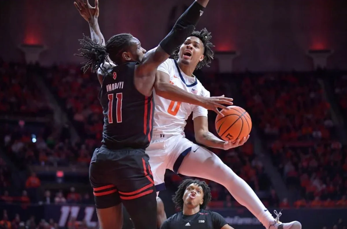 Jan 21, 2024; Champaign, Illinois, USA; Illinois Fighting Illini guard Terrence Shannon Jr. (0) drives to the basket as Rutgers Scarlet Knights center Clifford Omoruyi (11) defends during the first half at State Farm Center. credits: Ron Johnson-USA TODAY Sports