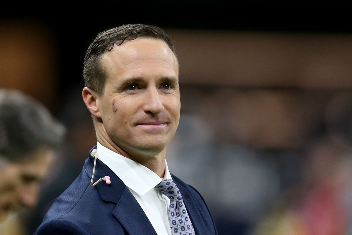 Nov 25, 2021; New Orleans, Louisiana, USA; Former New Orleans Saints quarterback Drew Brees stands on the sidelines before the game between the New Orleans Saints and the Buffalo Bills at the Caesars Superdome. Brees is b being honored at half-time of the game that he is also announcing for NBC. Mandatory Credit: Chuck Cook-Imagn Images