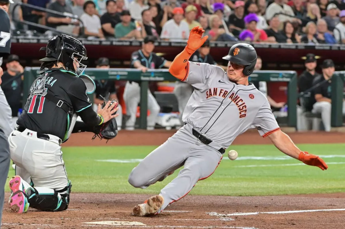Sep 23, 2024; Phoenix, Arizona, USA; San Francisco Giants third baseman Matt Chapman (26) slides home with an inside the park home run as Diamondbacks catcher Jose Herrera (11) defends in the third inning at Chase Field. Mandatory Credit: Matt Kartozian-Imagn Images