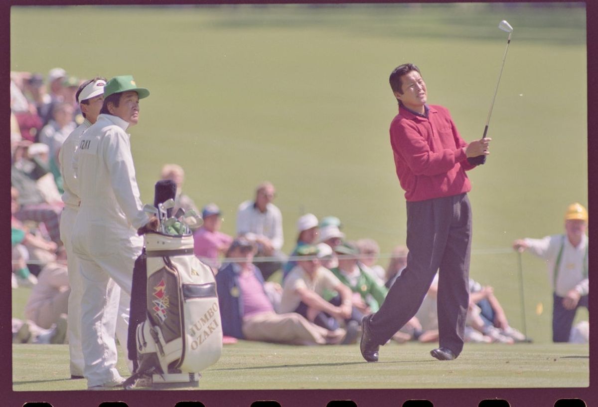04/04/1990; Augusta, Georgia, USA; Jumbo Ozaki drives the ball with an iron, Joe Ozaki and caddie watching at the Augusta National Golf Course during the 1990 Masters. Mandatory Credit: File Photo -The Augusta Chronicle via USA TODAY NETWORK