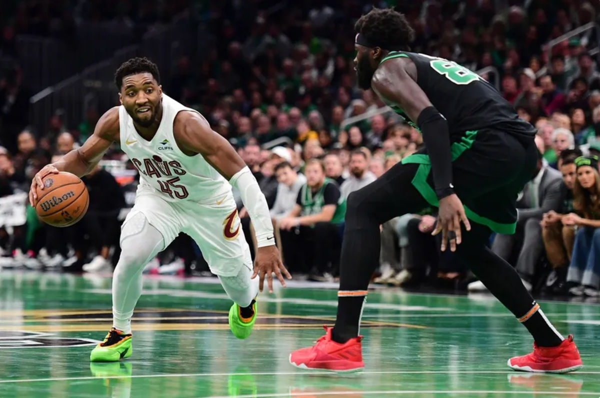 Nov 19, 2024; Boston, Massachusetts, USA; Cleveland Cavaliers guard Donovan Mitchell (45) controls the ball while Boston Celtics center Neemias Queta (88) defends during the second half at TD Garden. Mandatory Credit: Bob DeChiara-Imagn Images