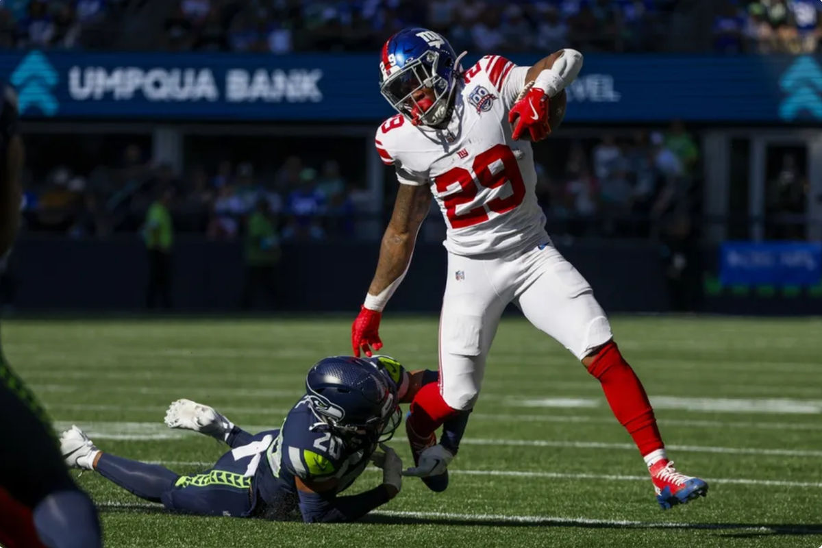 Oct 6, 2024; Seattle, Washington, USA; New York Giants running back Tyrone Tracy Jr. (29) breaks a tackle attempt by Seattle Seahawks safety Julian Love (20) during the second quarter at Lumen Field. Mandatory Credit: Joe Nicholson-Imagn Images