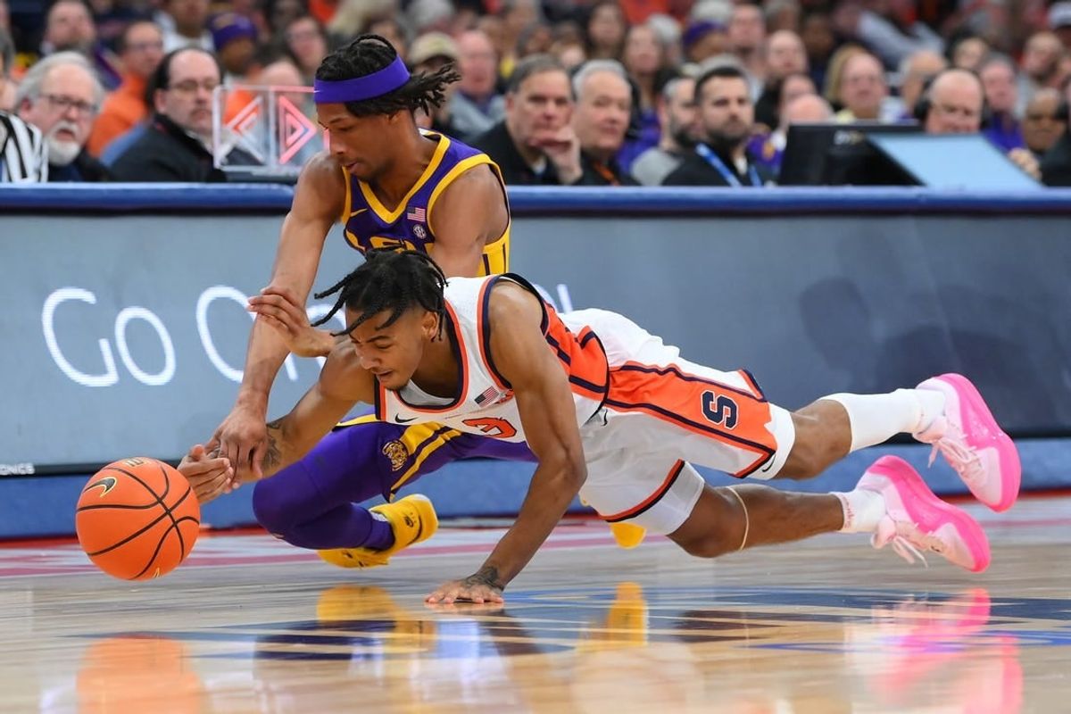 Nov 28, 2023; Syracuse, New York, USA; Syracuse Orange guard Judah Mintz (3) and LSU Tigers guard Mike Williams III (2) battle for a loose ball during the first half at the JMA Wireless Dome.