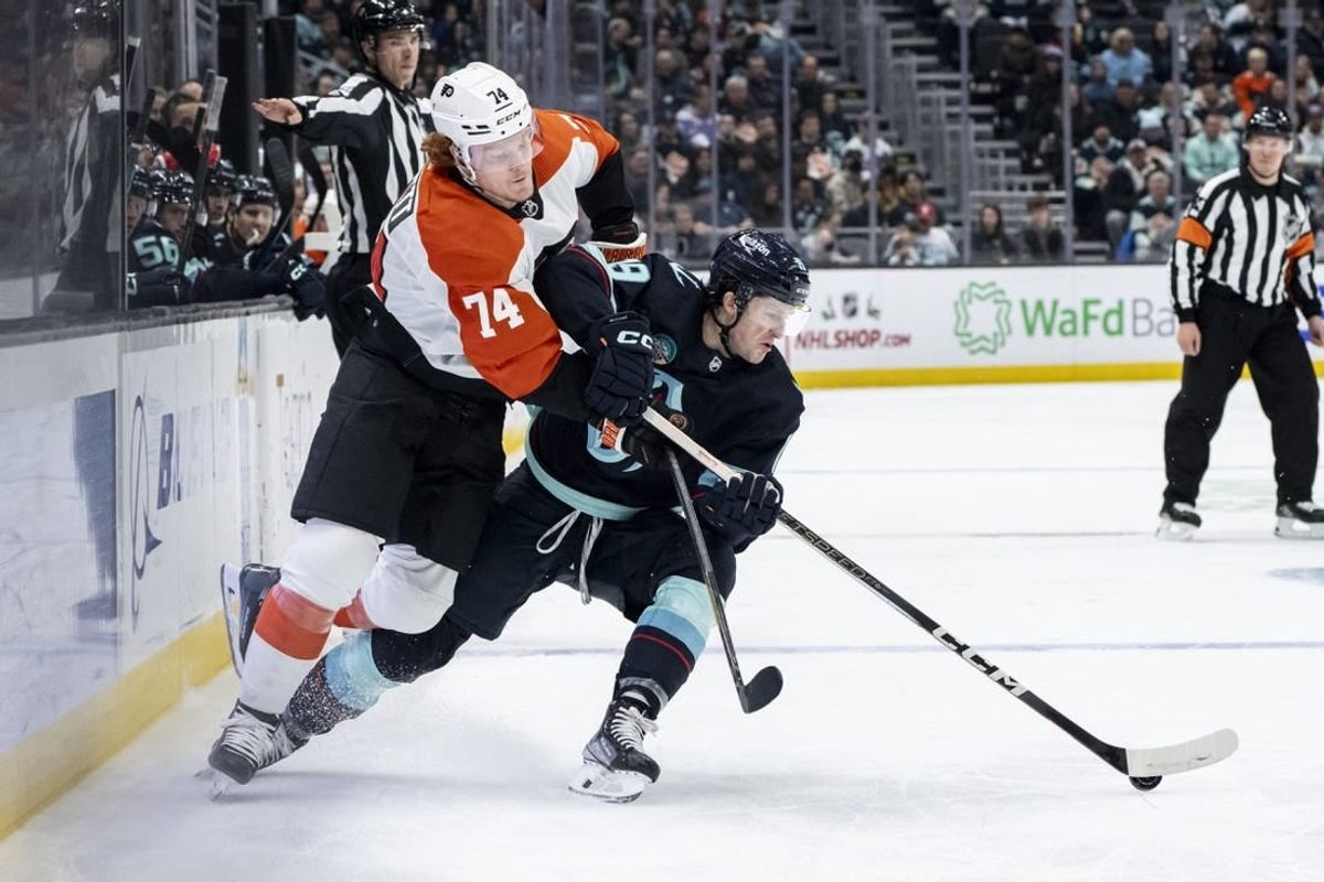 Dec 29, 2023; Seattle, Washington, USA; Seattle Kraken forward Jared McCann (19) and Philadelphia Flyers forward Owen Tippett (74) battle for the puck during the first period at Climate Pledge Arena.