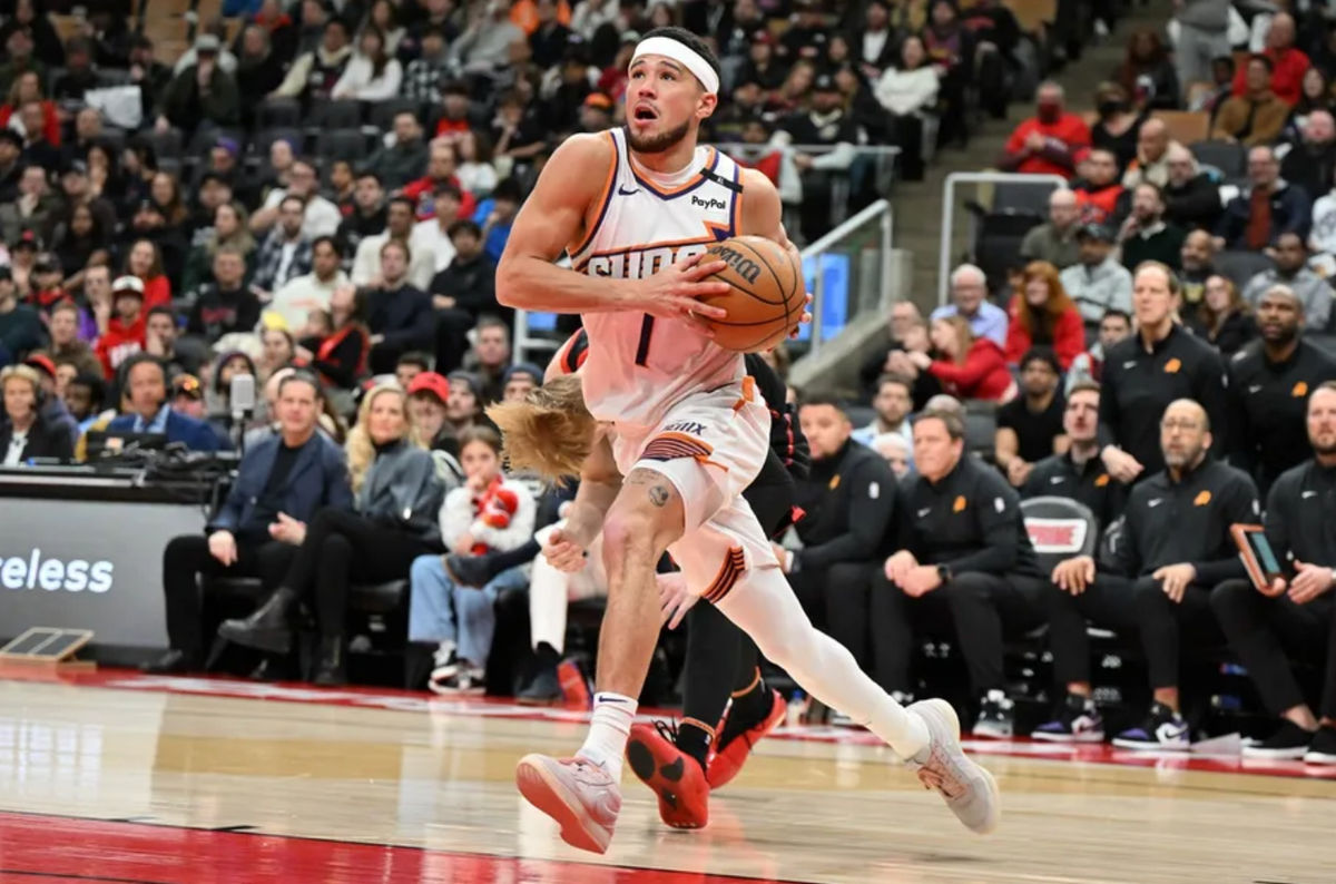 Feb 23, 2025; Toronto, Ontario, CAN; Phoenix Suns guard Devin Booker (1) drives to the basket against the Toronto Raptors in the second half at Scotiabank Arena. Mandatory Credit: Dan Hamilton-Imagn Images