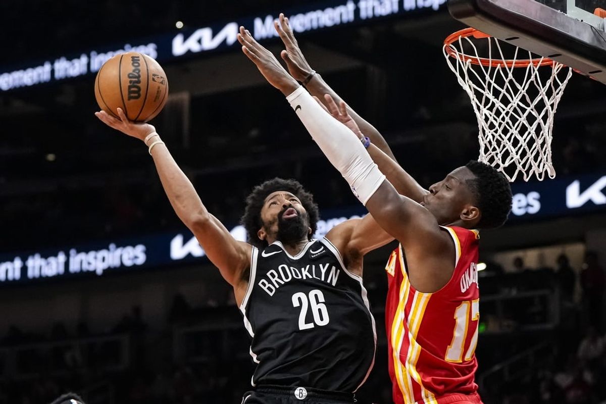 Dec 6, 2023; Atlanta, Georgia, USA; Brooklyn Nets guard Spencer Dinwiddie (26) shoots defended by Atlanta Hawks forward Onyeka Okongwu (17) during the second half at State Farm Arena.