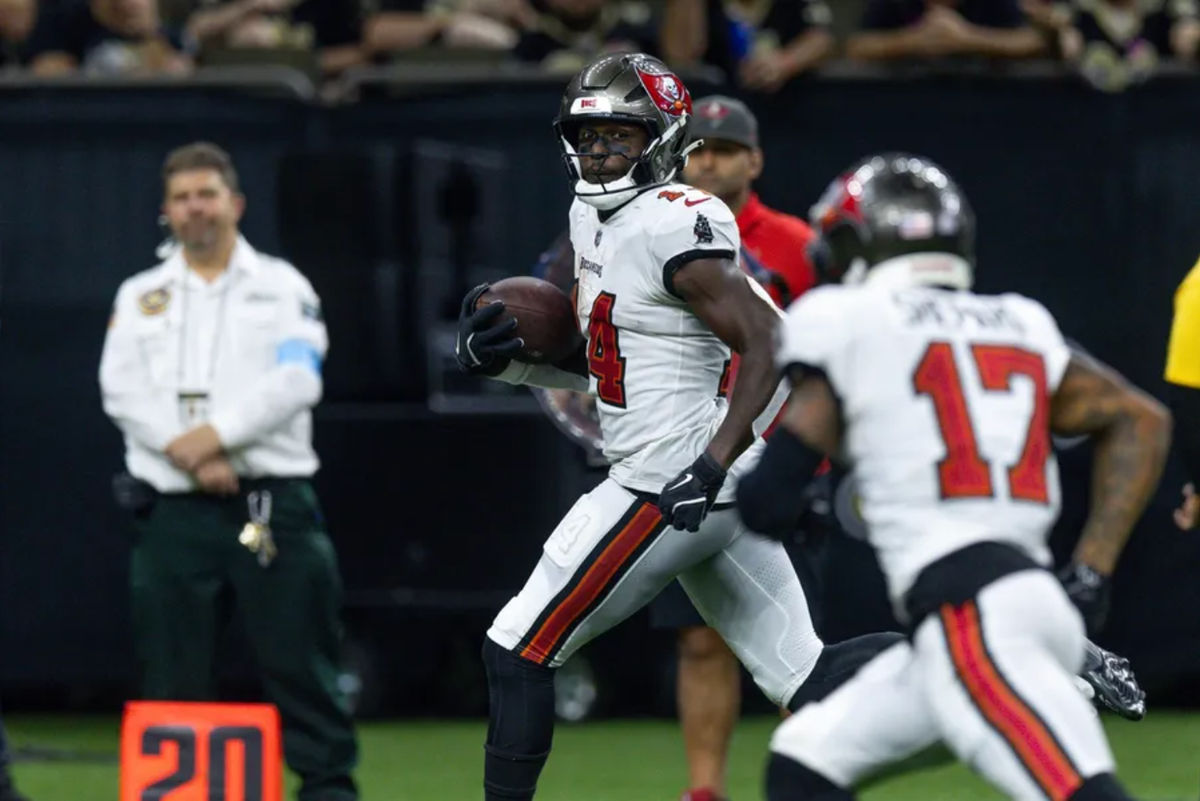 Oct 13, 2024; New Orleans, Louisiana, USA; Tampa Bay Buccaneers wide receiver Chris Godwin (14) looks back at wide receiver Sterling Shepard (17) as he runs in for a touchdown against the New Orleans Saints during the second half at Caesars Superdome. Mandatory Credit: Stephen Lew-Imagn Images