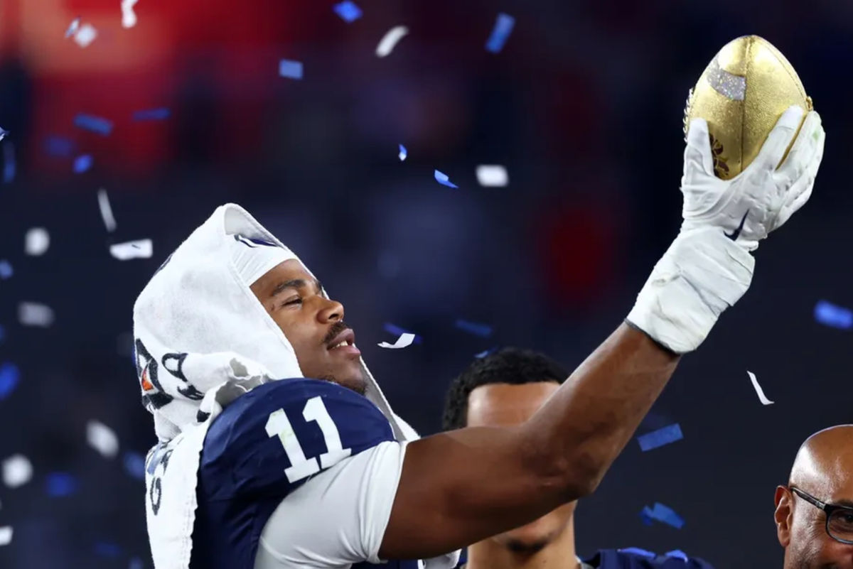 Dec 31, 2024; Glendale, AZ, USA; Penn State Nittany Lions defensive end Abdul Carter (11) reacts with the trophy after the game against the Boise State Broncos in the Fiesta Bowl at State Farm Stadium. Mandatory Credit: Mark J. Rebilas-Imagn Images