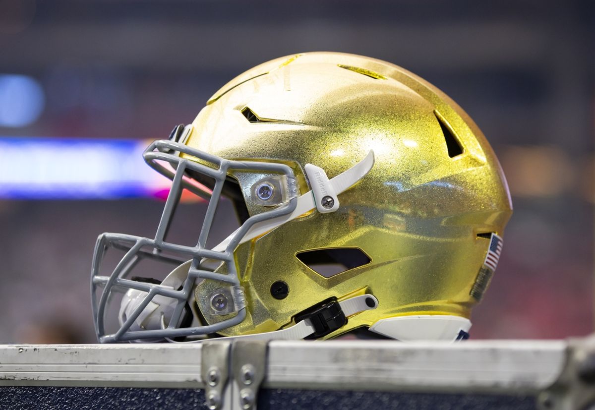 Jan 1, 2022; Glendale, Arizona, USA; Detailed view of a gold Notre Dame Fighting Irish helmet during the 2022 Fiesta Bowl at State Farm Stadium. Mandatory Credit: Mark J. Rebilas-Imagn Images