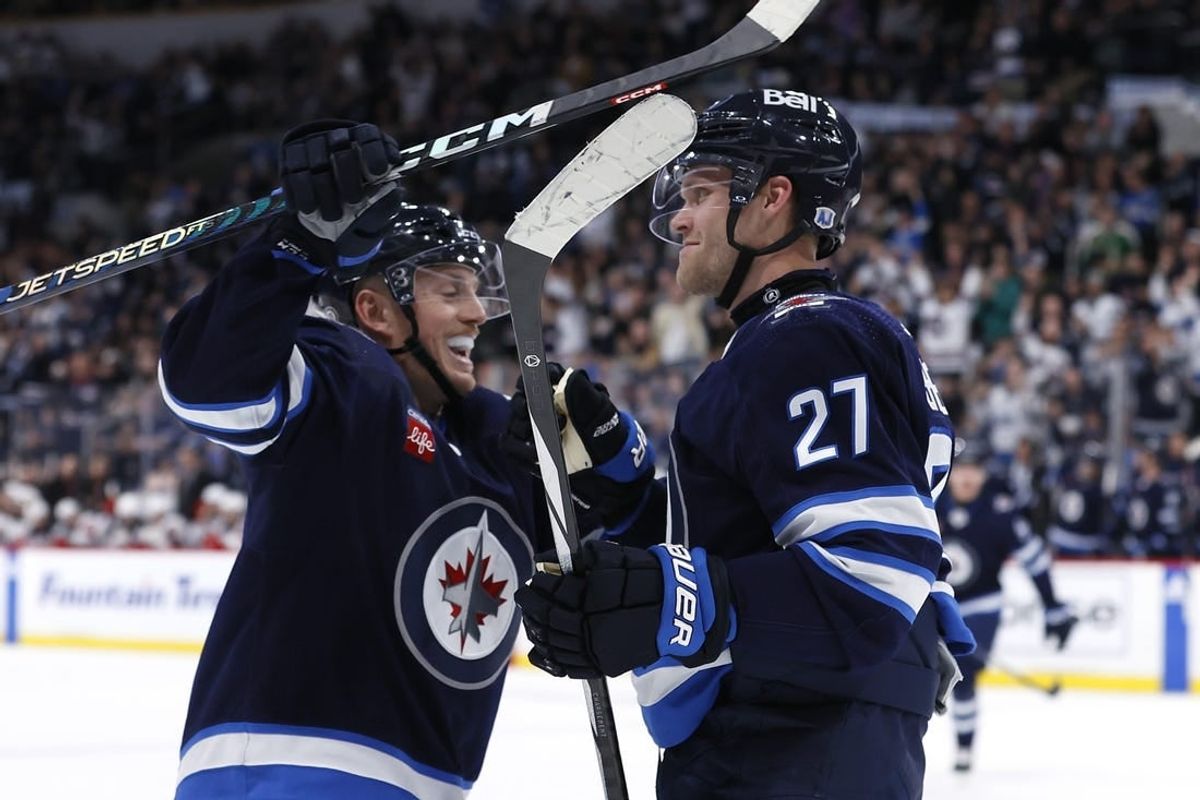 Nov 14, 2023; Winnipeg, Manitoba, CAN; Winnipeg Jets left wing Nikolaj Ehlers (27) celebrates his second period goal with Winnipeg Jets defenseman Nate Schmidt (88) against the New Jersey Devils at Canada Life Centre.