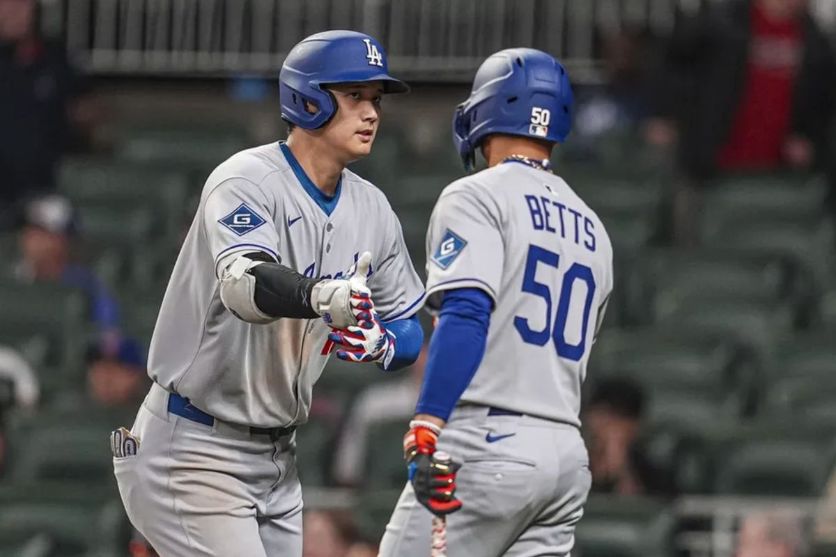 May 3, 2025; Cumberland, Georgia, USA; Los Angeles Dodgers designated hitter Shohei Ohtani (17) reacts with shortstop Mookie Betts (50) after hitting a home run against the Atlanta Braves during the third inning at Truist Park. Mandatory Credit: Dale Zanine-Imagn Images
