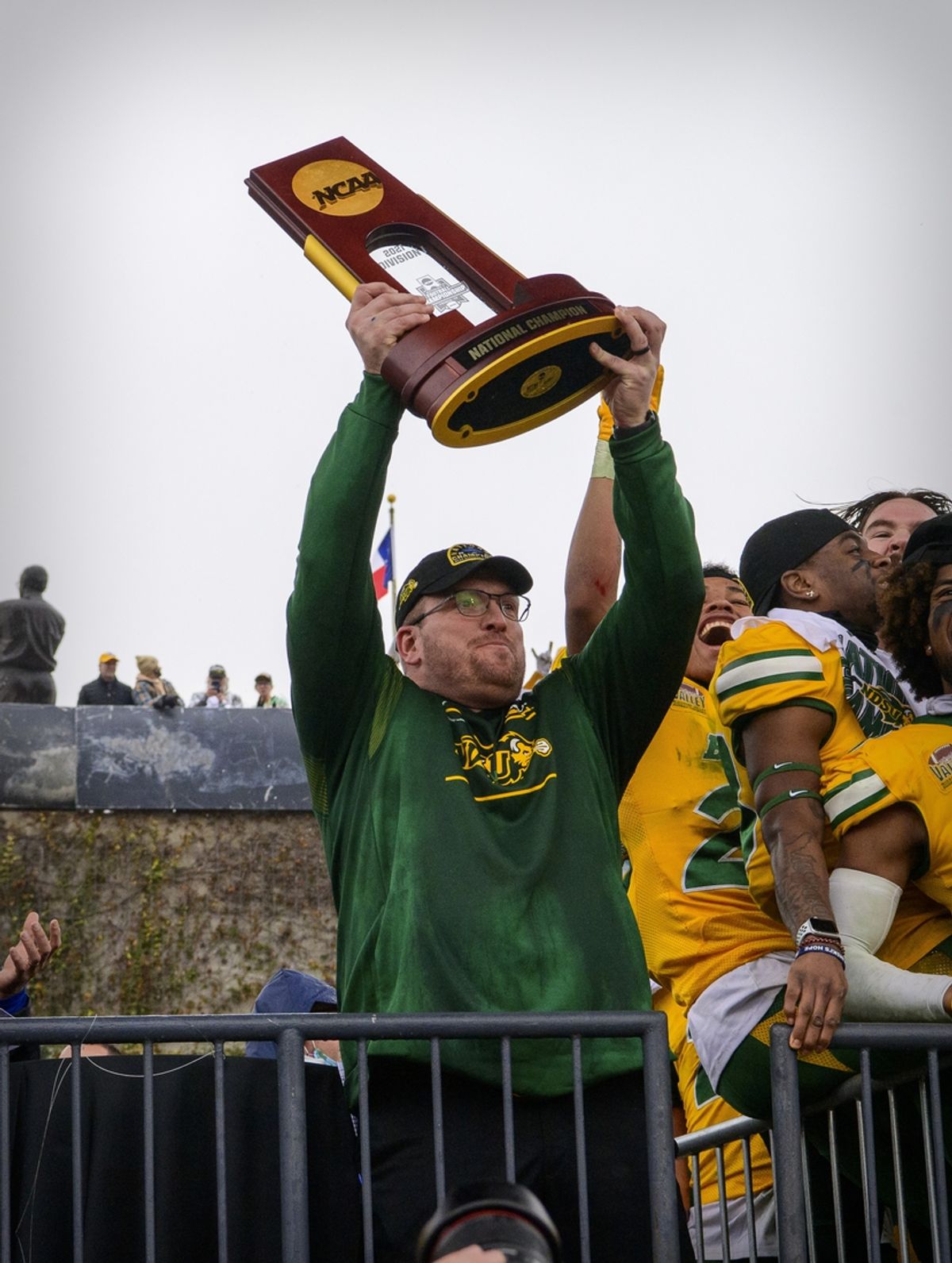 Jan 8, 2022; Frisco, TX, USA; North Dakota State Bison head coach Matt Entz holds up the championship trophy as the North Dakota State Bison team celebrates the win over the Montana State Bobcats in the FCS Championship at Toyota Stadium. Mandatory Credit: Jerome Miron-Imagn Images