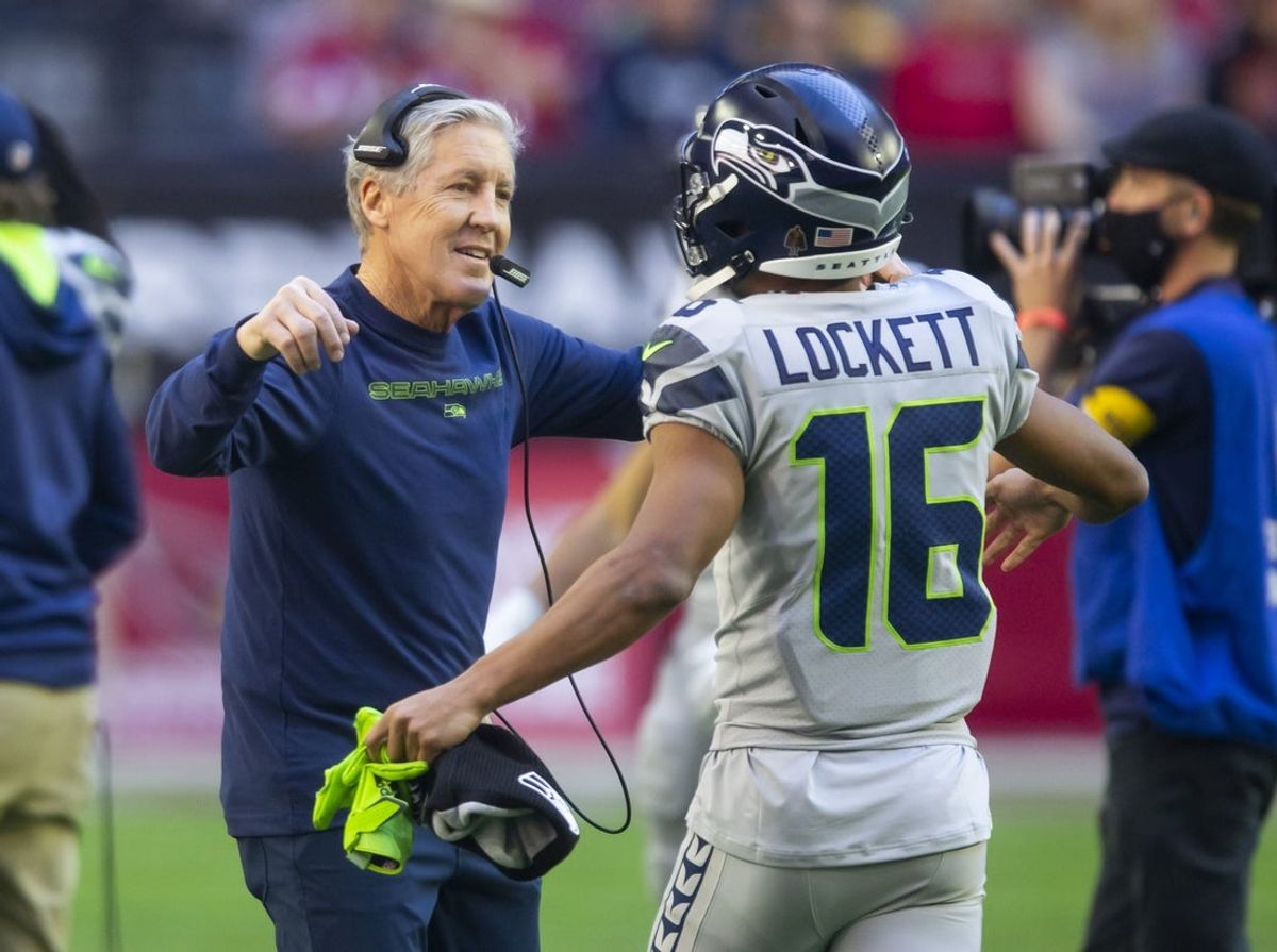 Jan 9, 2022; Glendale, Arizona, USA; Seattle Seahawks head coach Pete Carroll (left) hugs wide receiver Tyler Lockett (16) prior to the game against the Arizona Cardinals at State Farm Stadium. Mandatory Credit: Mark J. Rebilas-Imagn Images
