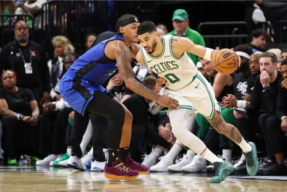 Apr 27, 2025; Orlando, Florida, USA; Boston Celtics forward Jayson Tatum (0) is guarded by Orlando Magic forward Paolo Banchero (5) in the second quarter during game four of first round for the 2025 NBA Playoffs at Kia Center. Mandatory Credit: Nathan Ray Seebeck-Imagn Images