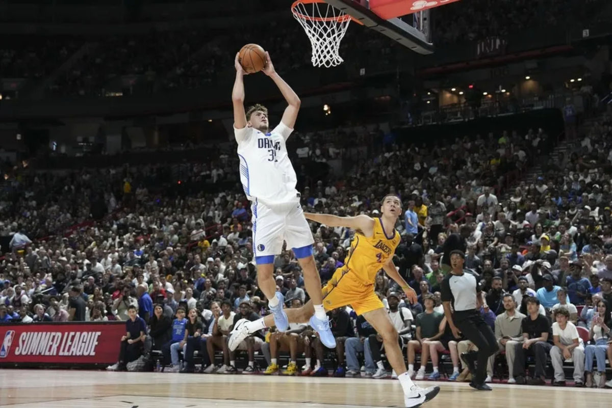 Jul 10, 2025; Las Vegas, NV, USA; Dallas Mavericks forward Cooper Flagg (32) is fouled by Los Angeles Lakers forward Cole Swider (41) in the first quarter of their game at Thomas & Mack Center. Mandatory Credit: Candice Ward-Imagn Images