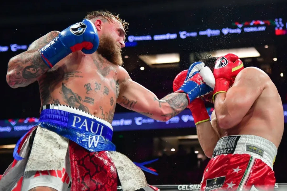 Jun 28, 2025; Anaheim, California, USA; Jake Paul moves in for a hit against Julio Cesar Chavez Jr. at Honda Center. Mandatory Credit: Gary A. Vasquez-Imagn Images