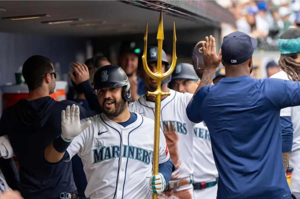 Aug 27, 2025; Seattle, Washington, USA; Seattle Mariners third baseman Eugenio Suarez (28) celebrates in the dugout after hitting a three-run home run during the fourth inning against the San Diego Padres at T-Mobile Park. Mandatory Credit: Stephen Brashear-Imagn Images