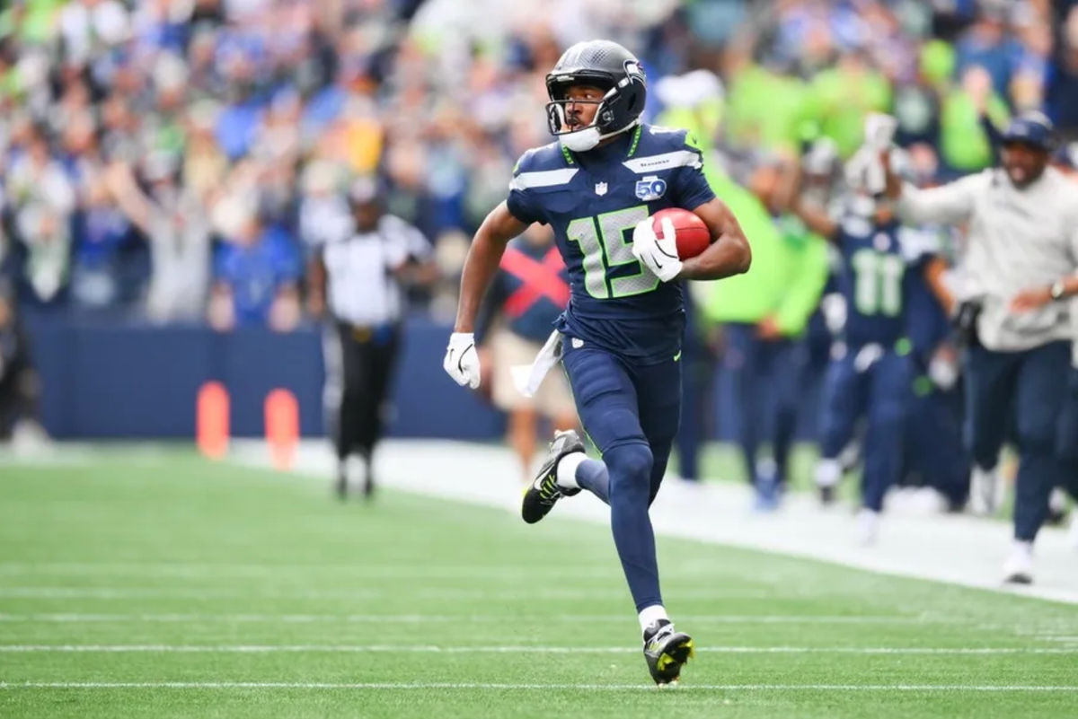 Sep 21, 2025; Seattle, Washington, USA; Seattle Seahawks wide receiver Tory Horton (15) makes a 95 yard punt return for a touchdown during the first quarter against the New Orleans Saints at Lumen Field. Mandatory Credit: Steven Bisig-Imagn Images