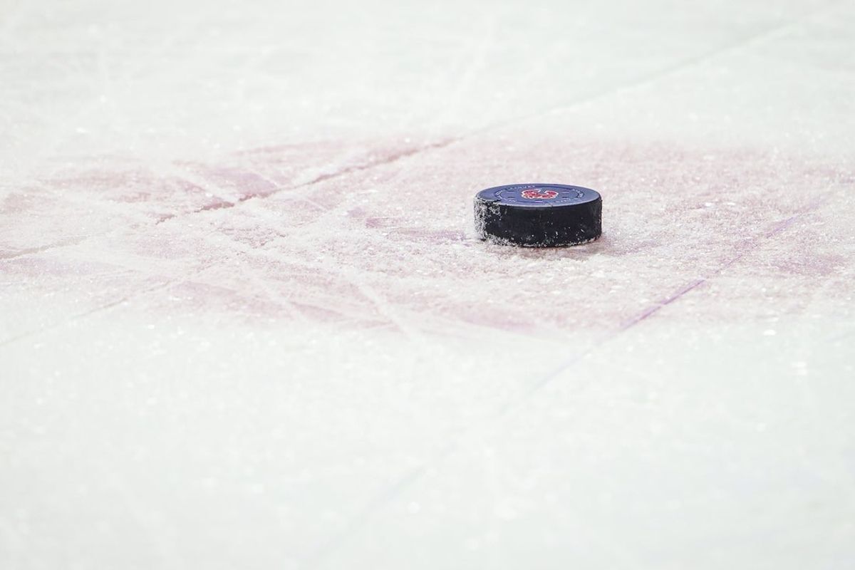 Jan 29, 2022; Calgary, Alberta, CAN; General view of the hockey puck during the third period between the Calgary Flames and the Vancouver Canucks at Scotiabank Saddledome. Mandatory Credit: Sergei Belski-Imagn Images