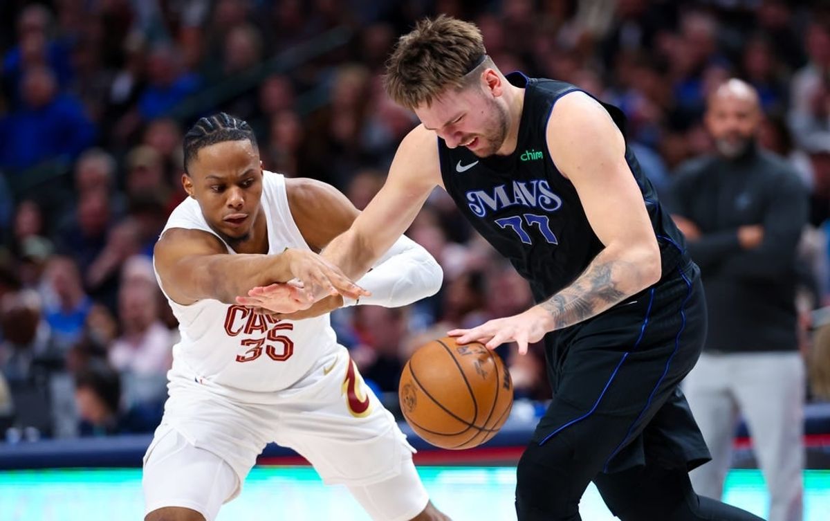 Dec 23, 2023; Dallas, Texas, USA;  Dallas Mavericks guard Luka Doncic (77) looks to controls the ball as Cleveland Cavaliers forward Isaac Okoro (35) defends during the second quarter at American Airlines Center.