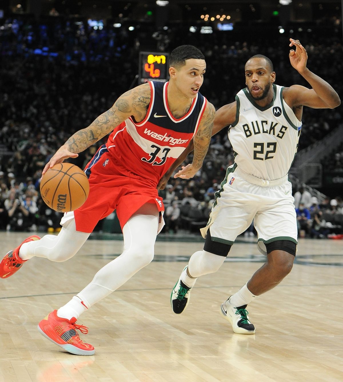 Feb 1, 2022; Milwaukee, Wisconsin, USA;  Washington Wizards forward Kyle Kuzma (33) drives to the basket against Milwaukee Bucks forward Khris Middleton (22) in the second half at Fiserv Forum. Mandatory Credit: Michael McLoone-Imagn Images
