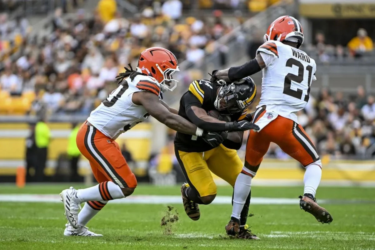 Oct 12, 2025; Pittsburgh, Pennsylvania, USA; Pittsburgh Steelers running back Kenneth Gainwell (14) runs the ball against Cleveland Browns defense during the first quarter at Acrisure Stadium. Mandatory Credit: Barry Reeger-Imagn Images