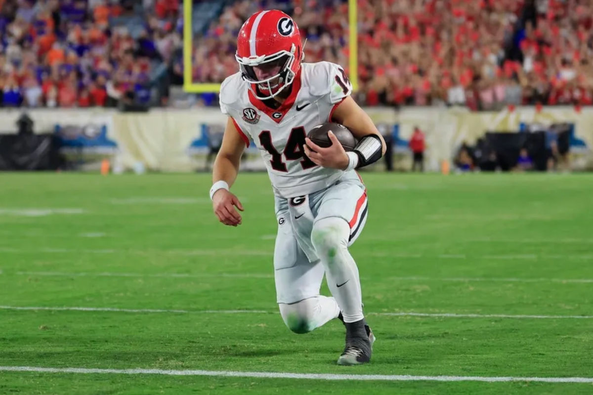 Georgia Bulldogs quarterback Gunner Stockton (14) kneels before the goal line to pick up the first down and run out the clock during the fourth quarter of an NCAA football game, Saturday, Nov. 1, 2025, at EverBank Stadium in Jacksonville, Fla. Georgia held off Florida 24-20. [Corey Perrine/Florida Times-Union]