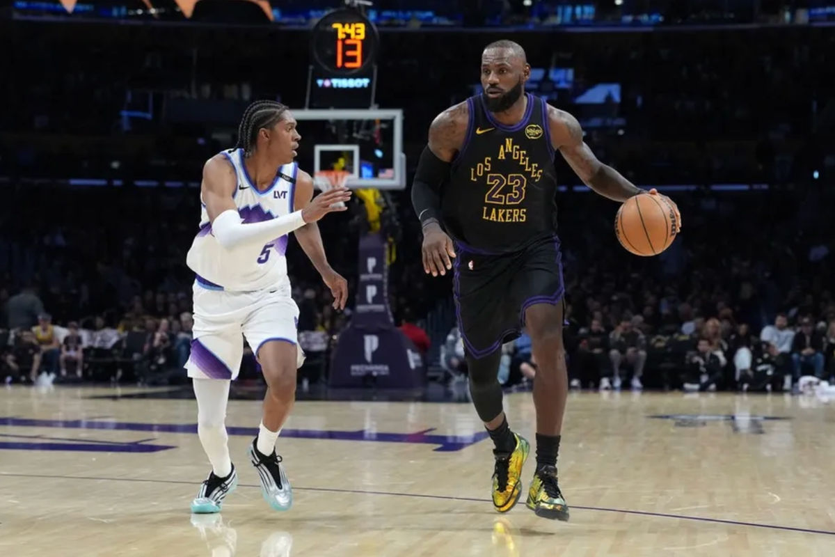 Nov 18, 2025; Los Angeles, California, USA; Los Angeles Lakers forward LeBron James (23) dribbles the ball against Utah Jazz forward Cody Williams (5) in the second quarter at Crypto.com Arena. Mandatory Credit: Kirby Lee-Imagn Images