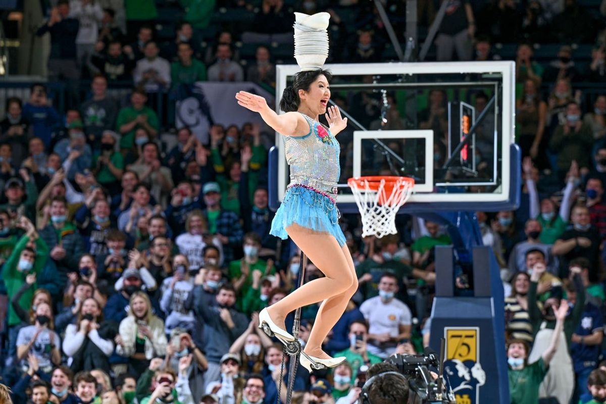Feb 9, 2022; South Bend, Indiana, USA; The Red Panda Acrobat performs during halftime of the game between the Notre Dame Fighting Irish and the Louisville Cardinals at the Purcell Pavilion. Mandatory Credit: Matt Cashore-Imagn Images
