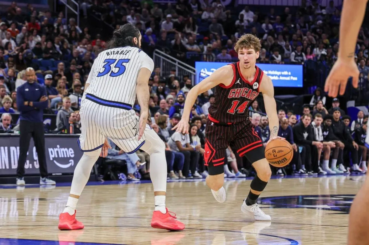 Dec 1, 2025; Orlando, Florida, USA; Chicago Bulls forward Matas Buzelis (14) drives against Orlando Magic center Goga Bitadze (35) during the second half at Kia Center. Mandatory Credit: Mike Watters-Imagn Images