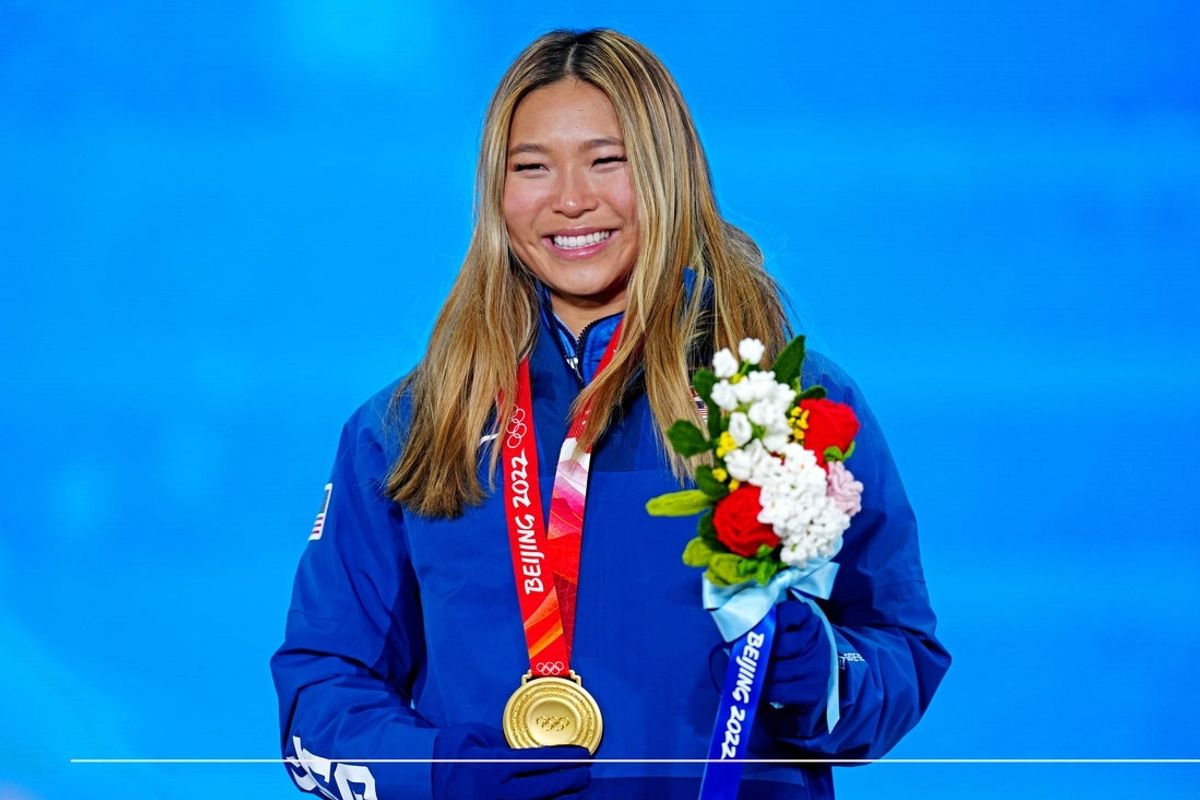 Feb 10, 2022; Zhangjiakou, CHINA; Chloe Kim (USA) celebrates winning the gold medal during the medals ceremony for Women   s Snowboard Halfpipe the  at the Beijing 2022 Olympic Winter Games at Zhangjiakou Medals Plaza. Mandatory Credit: Danielle Parhizkaran-Imagn Images