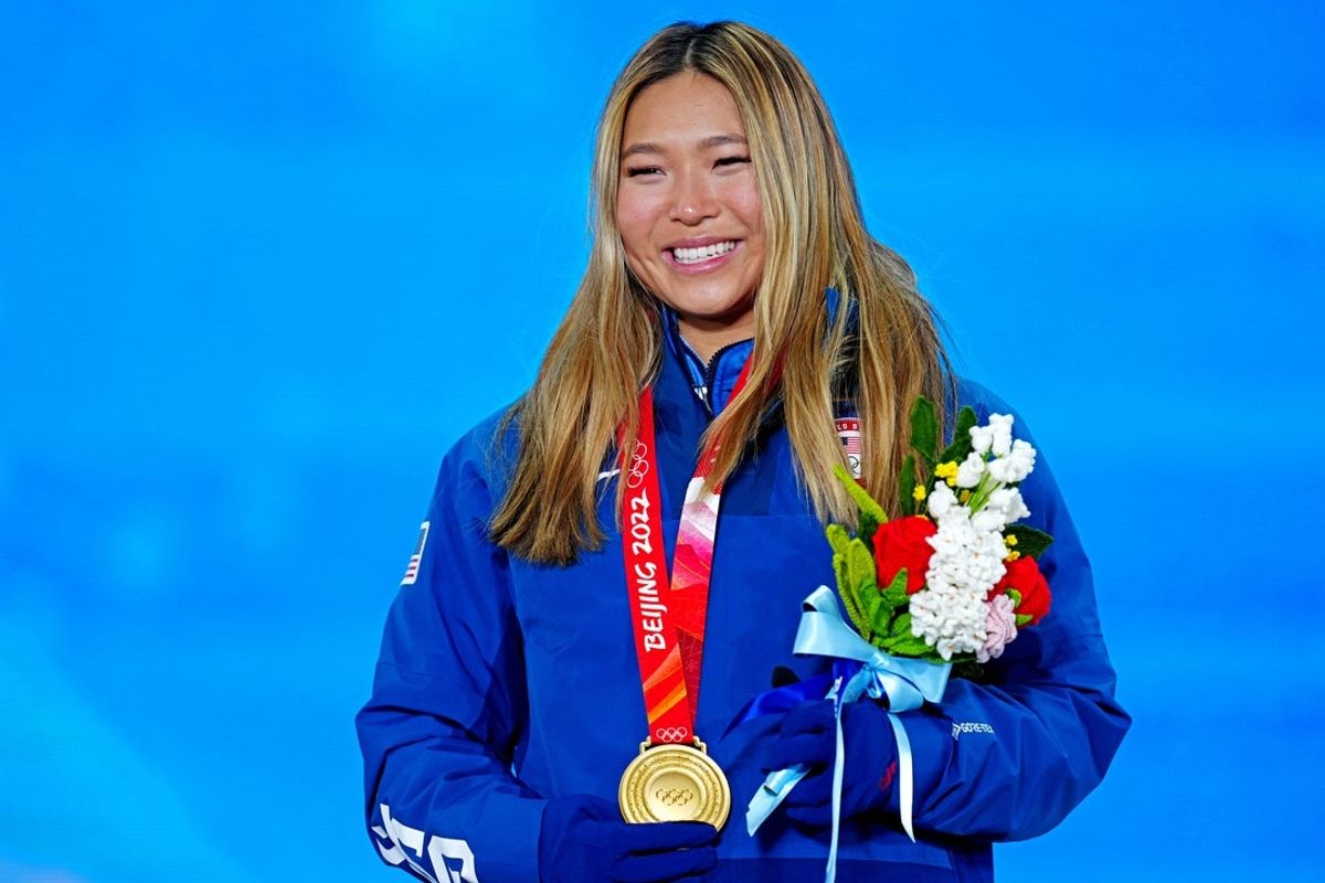 Feb 10, 2022; Zhangjiakou, CHINA; Chloe Kim (USA) celebrates winning the gold medal during the medals ceremony for Women   s Snowboard Halfpipe the  at the Beijing 2022 Olympic Winter Games at Zhangjiakou Medals Plaza. Mandatory Credit: Danielle Parhizkaran-Imagn Images