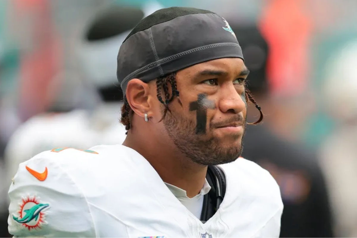 Oct 12, 2025; Miami Gardens, Florida, USA; Miami Dolphins quarterback Tua Tagovailoa (1) looks on from thevbench against the Los Angeles Chargers during the fourth quarter at Hard Rock Stadium. Mandatory Credit: Sam Navarro-Imagn Images