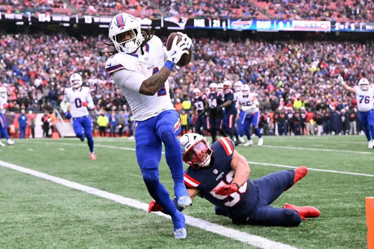 Dec 14, 2025; Foxborough, Massachusetts, USA; Buffalo Bills running back James Cook III (4) scores a touchdown against the New England Patriots during the first half at Gillette Stadium. Mandatory Credit: Brian Fluharty-Imagn Images