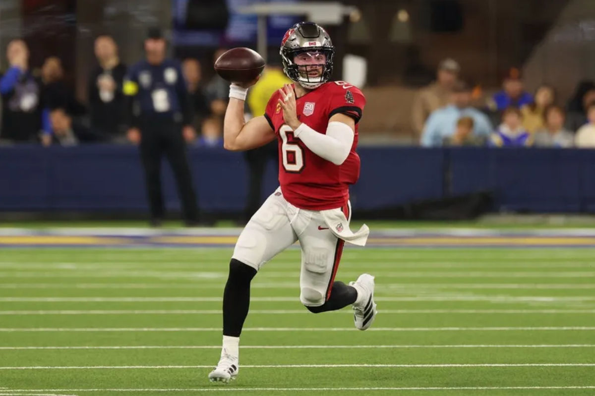 Nov 23, 2025; Inglewood, California, USA; Tampa Bay Buccaneers quarterback Baker Mayfield (6) looks to throw a pass while running with the ball against the Los Angeles Rams during the first quarter at SoFi Stadium. Mandatory Credit: Kiyoshi Mio-Imagn Images