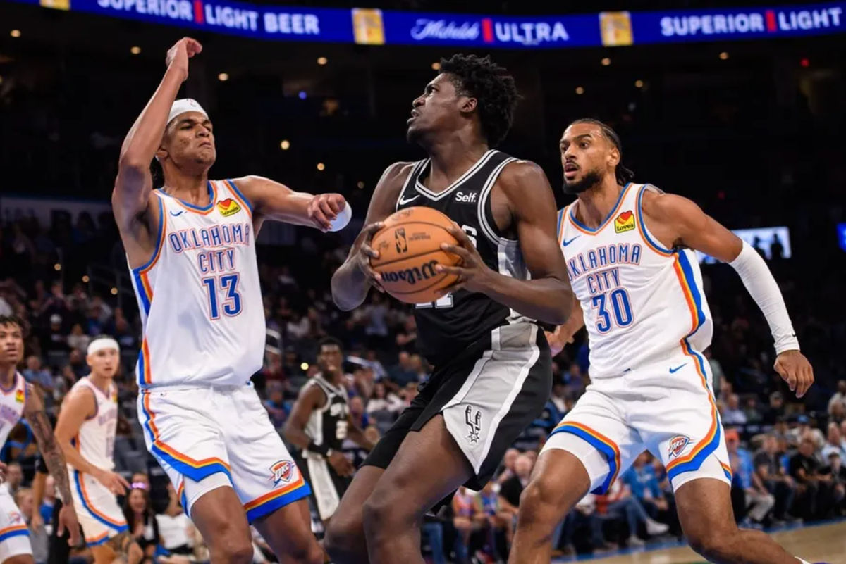 Oct 9, 2023; Oklahoma City, Oklahoma, USA; San Antonio Spurs center Charles Bediako (27) goes to the basket while defended by Oklahoma City Thunder forward Ousmane Dieng (13) during the second half at Paycom Center. Mandatory Credit: Rob Ferguson-Imagn Images