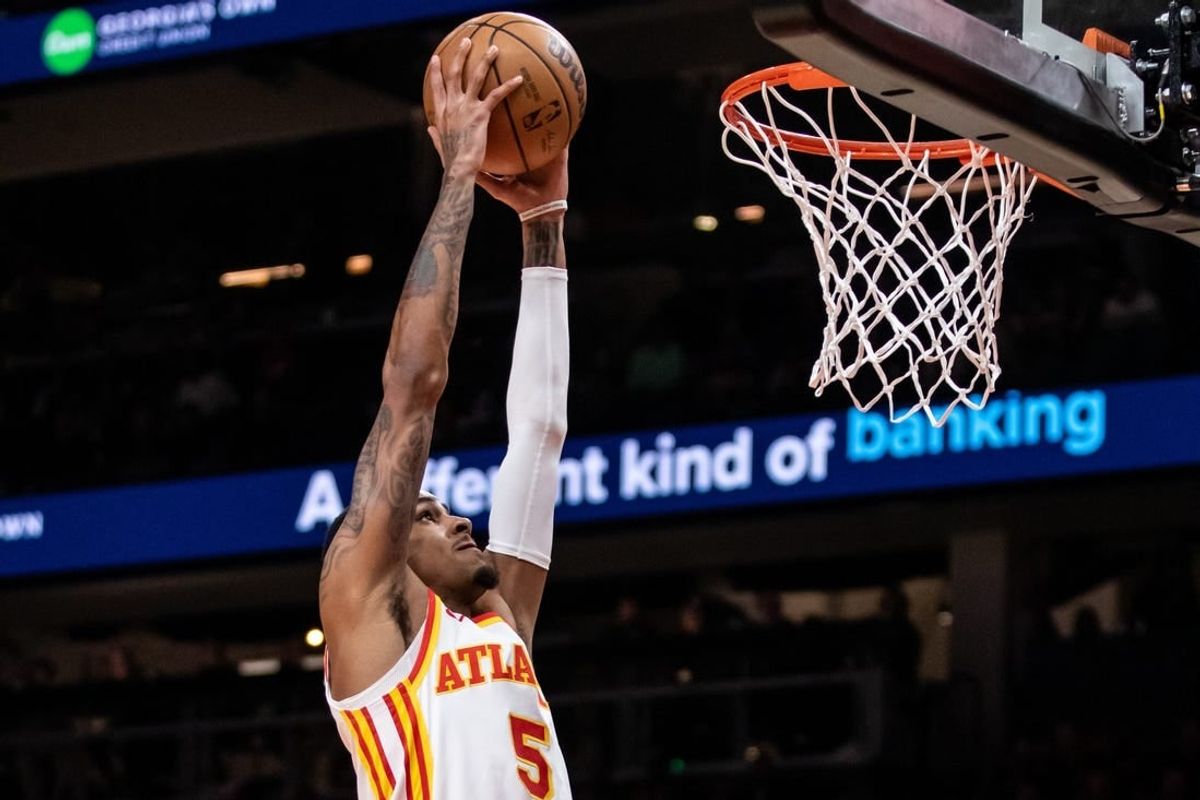 Feb 3, 2024; Atlanta, Georgia, USA; Atlanta Hawks guard Dejounte Murray (5) dunks against Golden State Warriors during the first quarter at State Farm Arena.