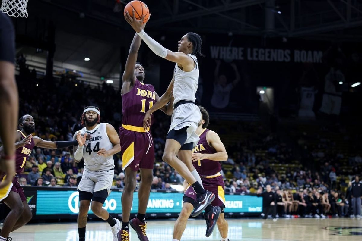 Nov 26, 2023; Boulder, Colorado, USA; Colorado Buffaloes forward Cody Williams (10) goes to the basket against Iona Gaels forward Sultan Adewale (11) during the second half at CU Events Center.