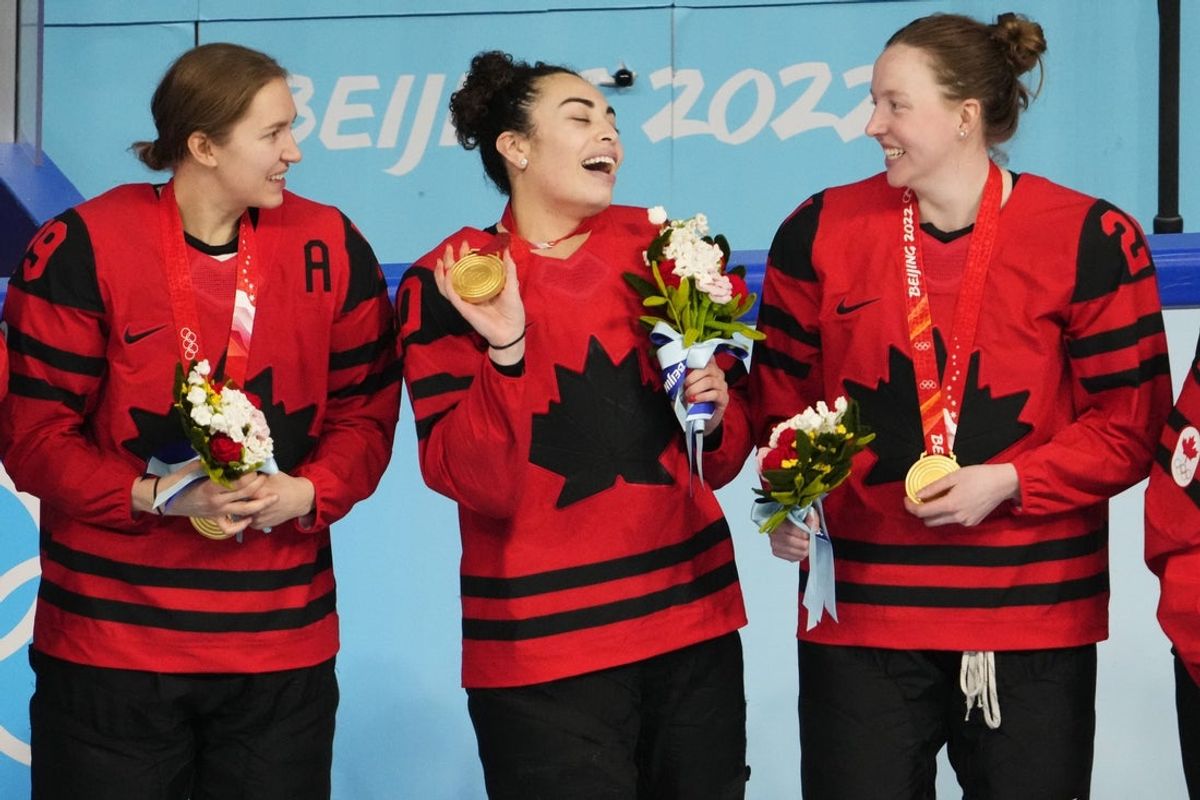 Feb 17, 2022; Beijing, China; Team Canada forward Sarah Nurse (20) celebrates with Team Canada forward Brianne Jenner (19) and Team Canada defender Ashton Bell (21) during the medals ceremony during the Beijing 2022 Olympic Winter Games at Wukesong Sports Centre. Mandatory Credit: Rob Schumacher-Imagn Images