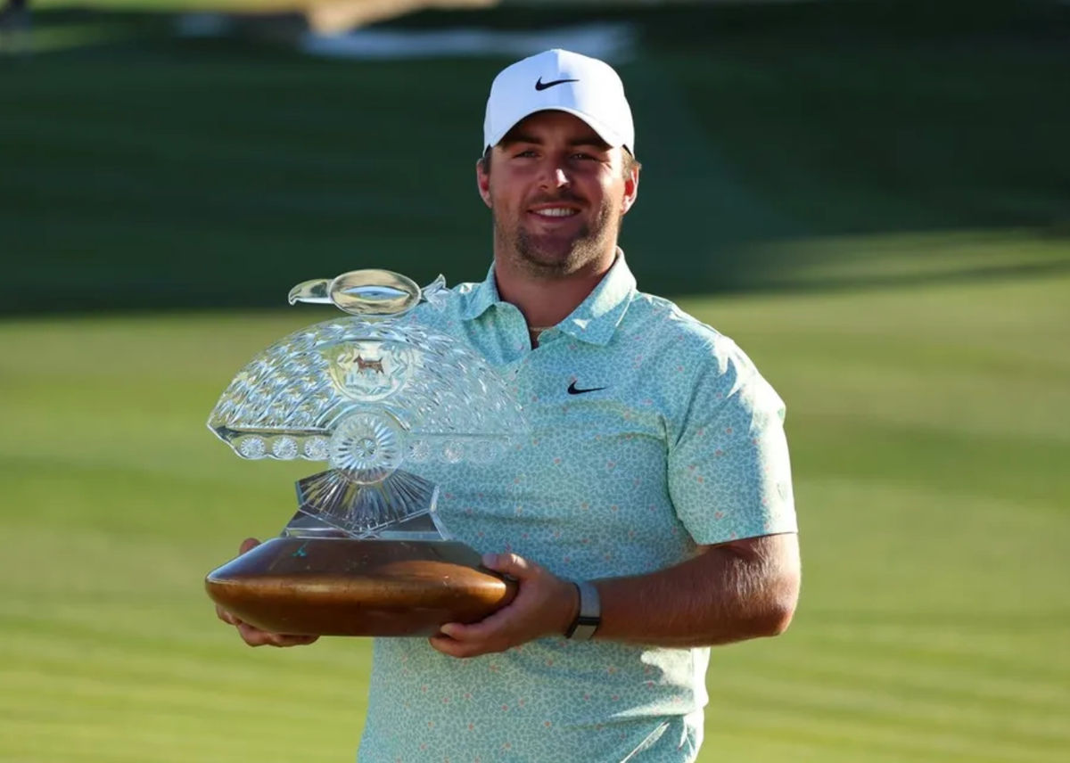 Feb 8, 2026; Scottsdale, Arizona, USA; Chris Gotterup of the United States celebrates his win with the trophy after the final round of the WM Phoenix Open golf tournament. Mandatory Credit: Anna Carrington-Imagn Images