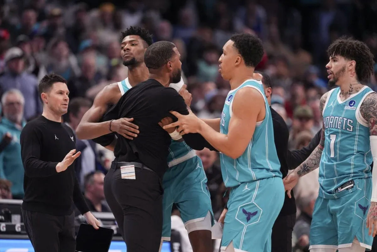 Feb 9, 2026; Charlotte, North Carolina, USA; Charlotte Hornets forward Brandon Miller (24) and forward Grant Williams (2) hold back Head Coach Charles Lee after his ejection during the second half against the Detroit Pistons at Spectrum Center. Mandatory Credit: Jim Dedmon-Imagn Images