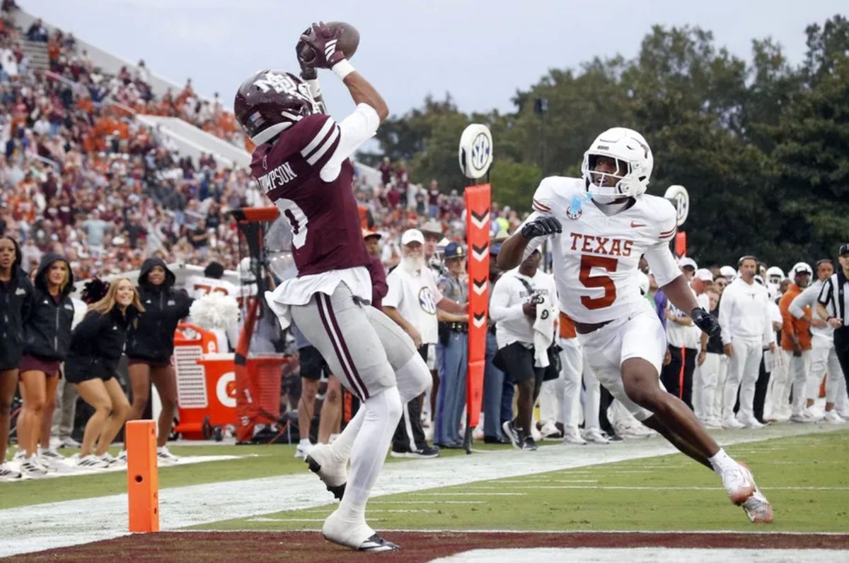 Oct 25, 2025; Starkville, Mississippi, USA; Mississippi State Bulldogs wide receiver Brenen Thompson (0) catches the ball for a touchdown over Texas Longhorns defensive back Malik Muhammad (5) during the second quarter at Davis Wade Stadium at Scott Field. Mandatory Credit: Petre Thomas-Imagn Images